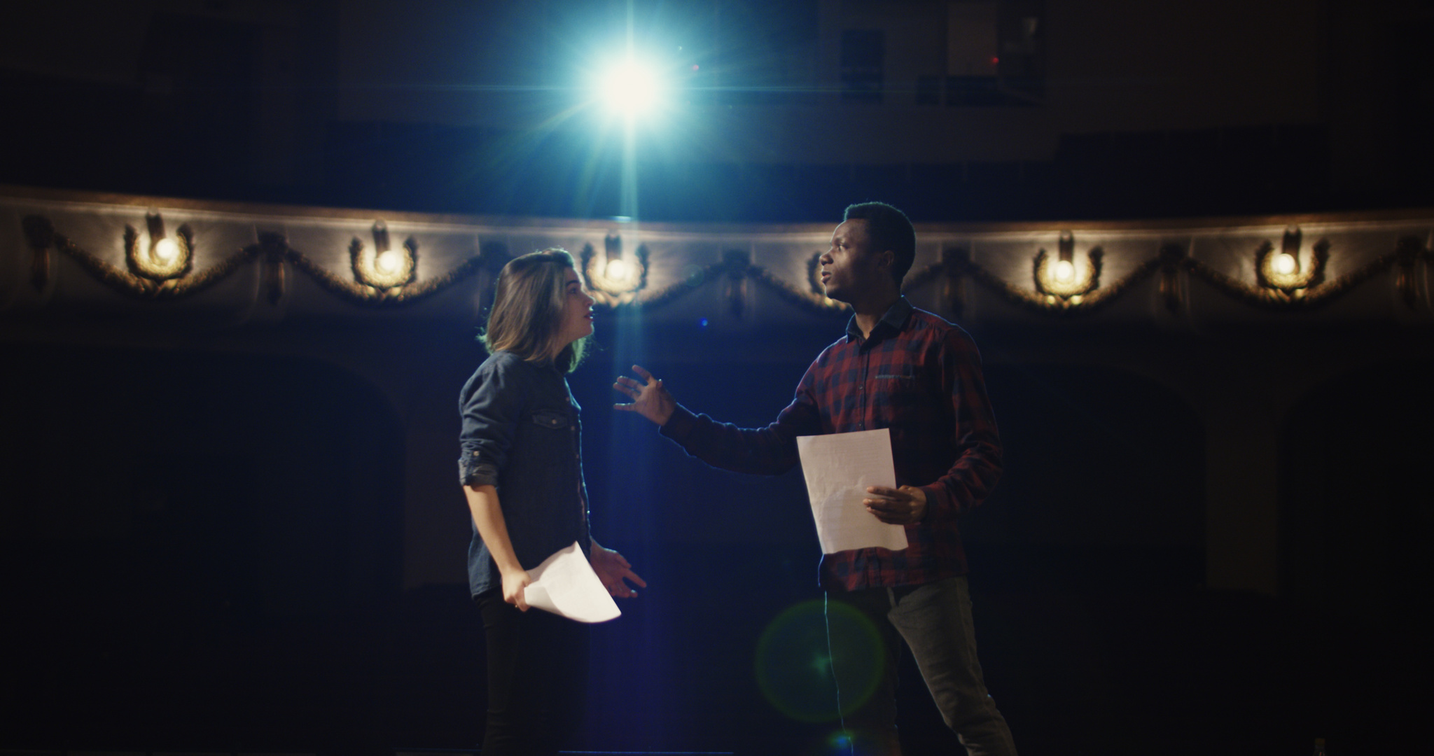 Actors rehearsing a scene in a theater
